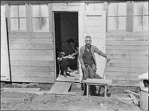 Dorothea Lange, a family settle into their new home, a former horse stall, San Bruno, California Dorothea Lange, a family settle into their new home, a former horse stall, San Bruno, California