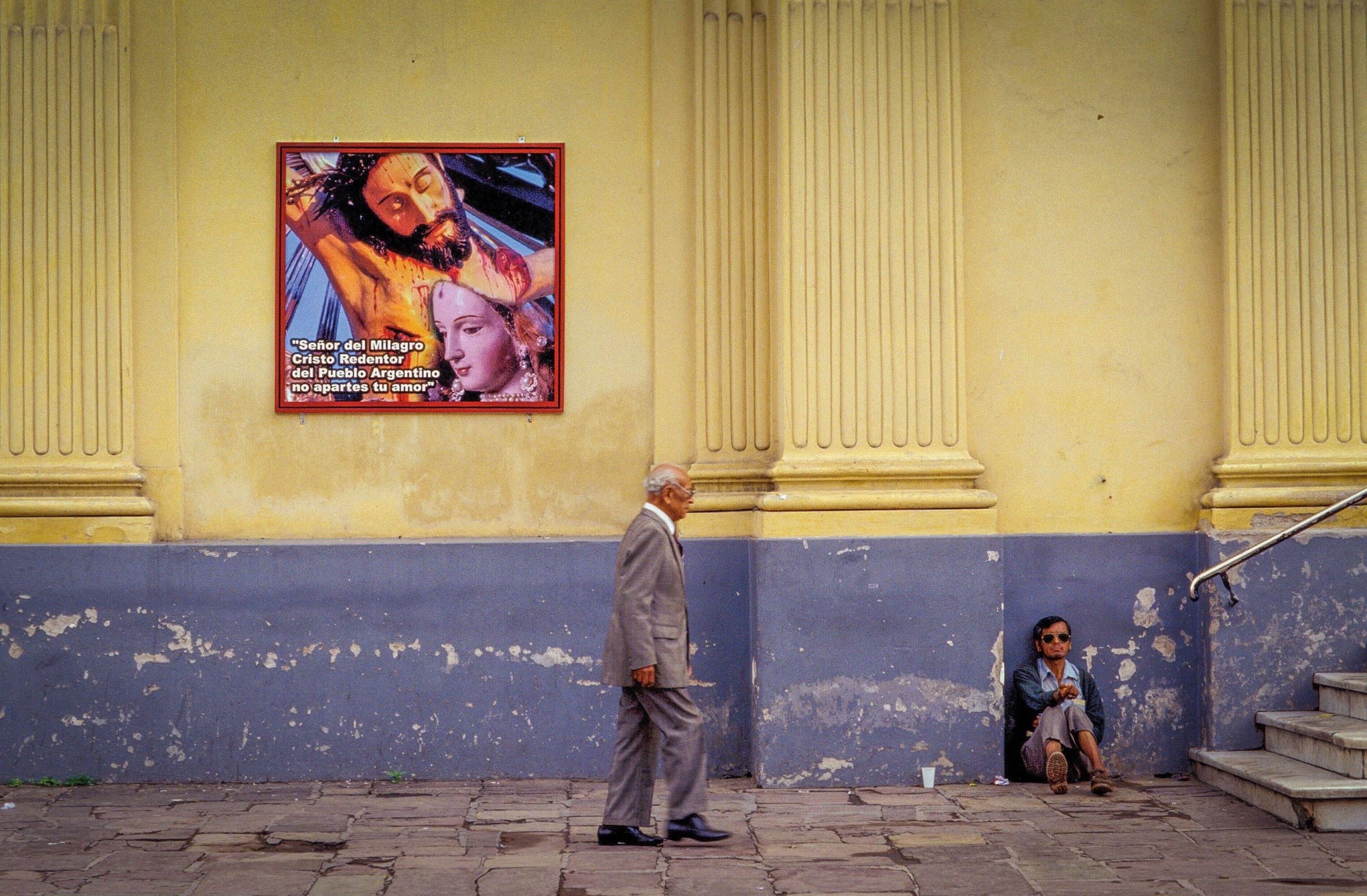 A man asks for money outside the cathedral in Salta, Argentina. Credit: Alamy A man sits on the pavement begging for money as a man in a suit walks by, next to the cathedral in Salta, Argentina