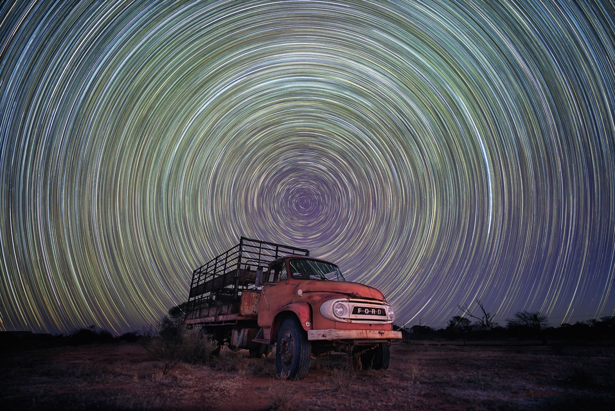 Star trails from the Earth’s rotation captured using long exposure, above a cattle truck in the Western Australian Wheatbelt