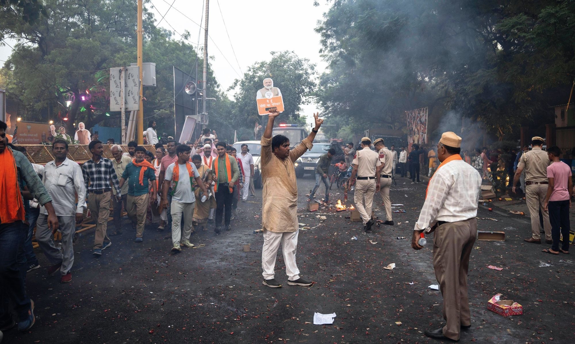 Supporters of Prime Minister Modi celebrate after he won a third consecutive term in June. Credit: Alamy Supporters of Indian Prime Minister Narendra Modi celebrate in the street after he won a third consecutive term in June. In the centre, one man holds up a paper cutout of Modi in one hand while flashing the V for Victory sign with the other hand