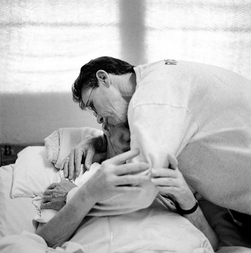 A volunteer comforts a terminally ill prisoner in the Angola Hospice, photo Lori Waselchuk Volunteer at the Angola hospice