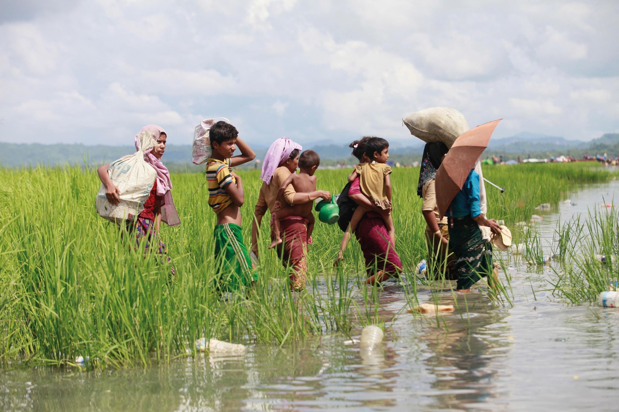 Rohingya refugees cross a river