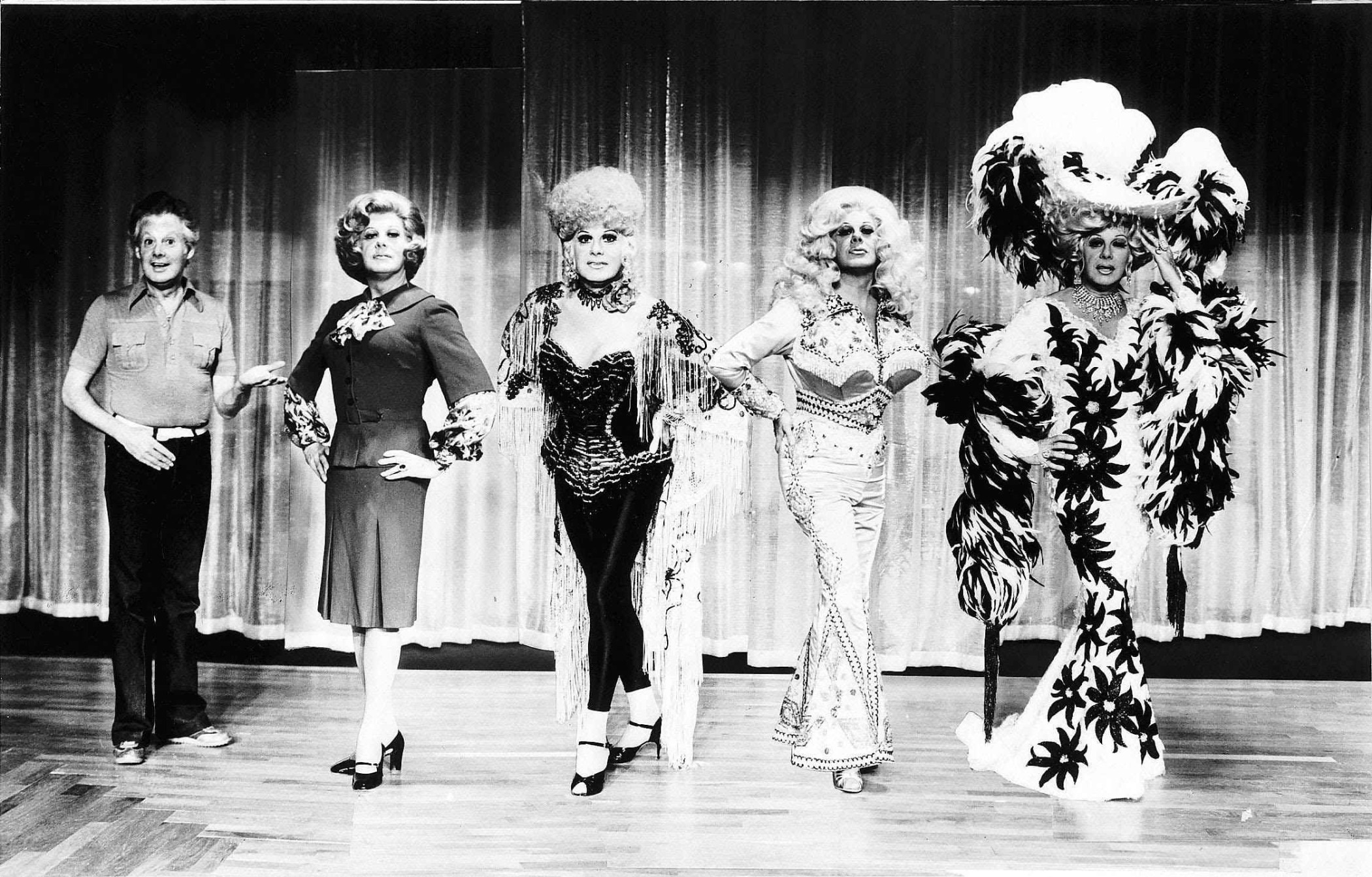 Danny La Rue dressed variously as Margaret Thatcher, Bette Midler, Dolly Parton and Mae West Danny La Rue dressed as Margaret Thatcher, Bette Midler, Dolly Parton and Mae West