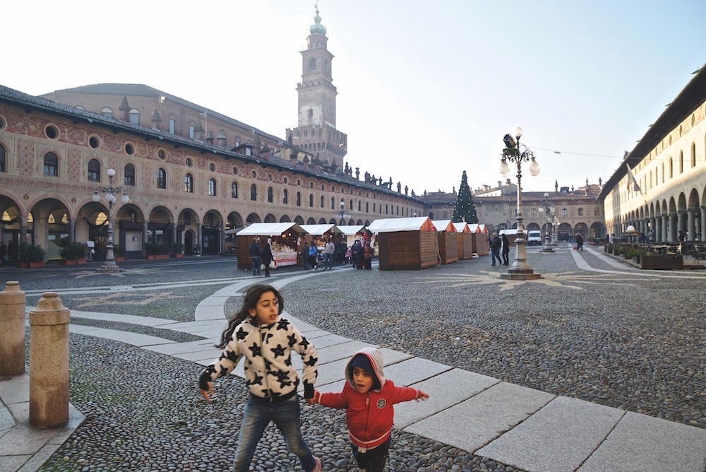 Children run through an Italian square