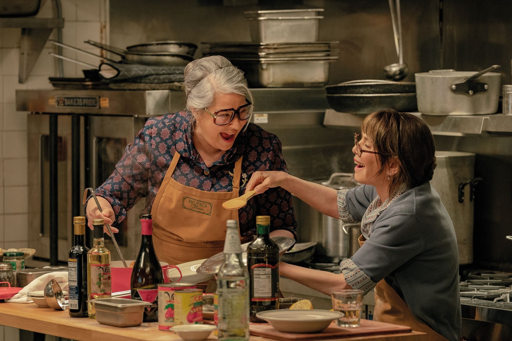 Left to right: Lorraine Bracco as Roberta and Talia Shire as Teresa in “Nonnas”. Credit: Jeong Park/Netflix © 2025 In a scene from 'Nonnas', two characters - Roberta and Teresa - laugh together as they cook