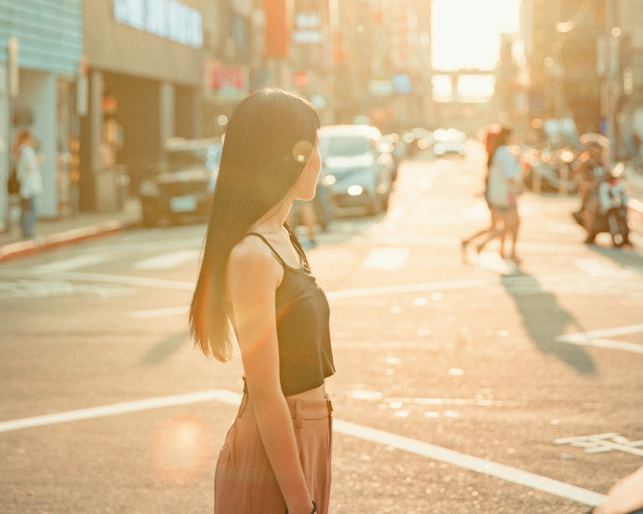 Credit: Unsplash A woman stands in the middle of a busy road