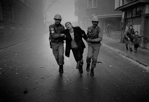 One of Paul Lowe’s photos – a woman being rescued by peacekeepers – from the siege of Sarajevo in 1993 Paul Lowe photo