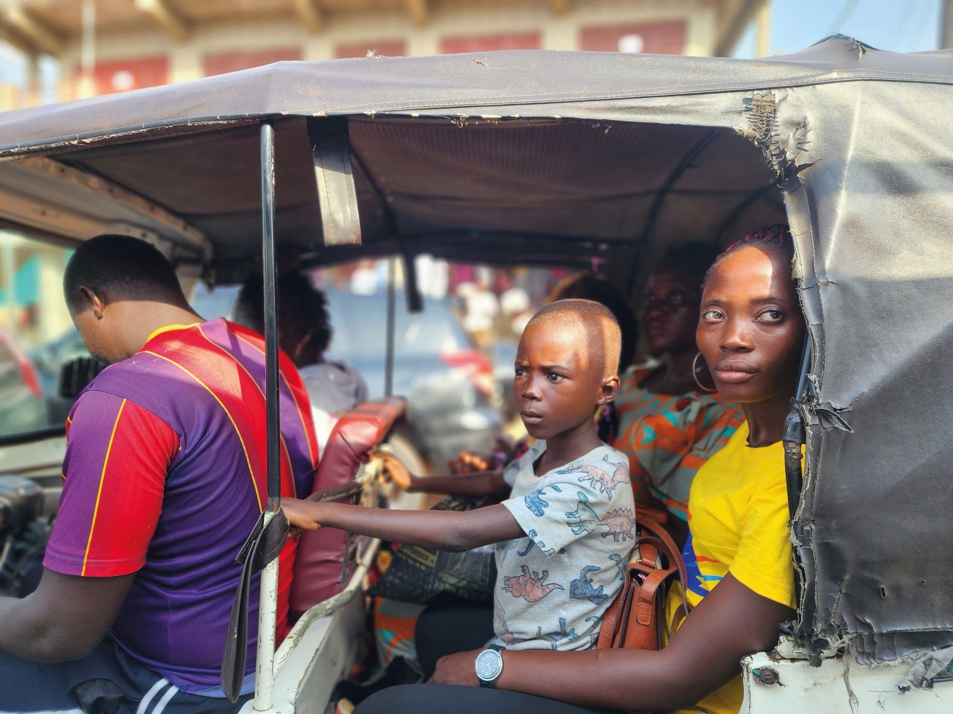 A boy and his mother travel in an auto-rickshaw in Freetown, Sierra Leone. Credit: Jody Ray A boy and his mother travel in an auto-rickshaw in Freetown, Sierra Leone