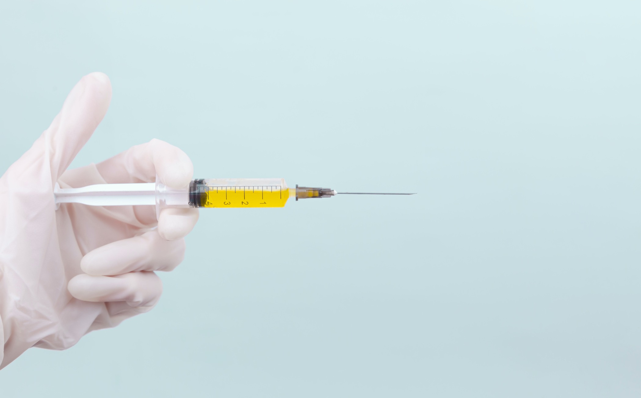 A stock photo of a syringe containing a yellow liquid