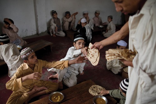 Students receive bread at a madrasa in Rawalpindi, Pakistan madrasa