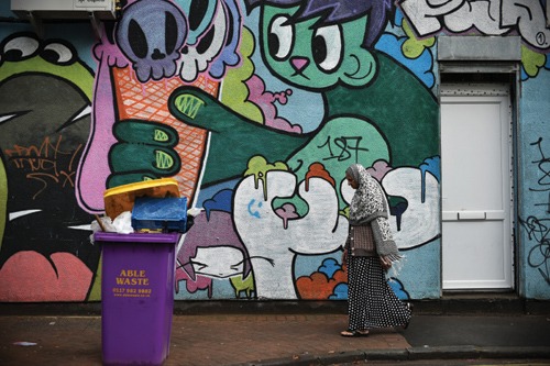 A woman walks past graffiti in the Stokes Croft area of Bristol A woman walks past graffiti in the Stokes Croft area of Bristol